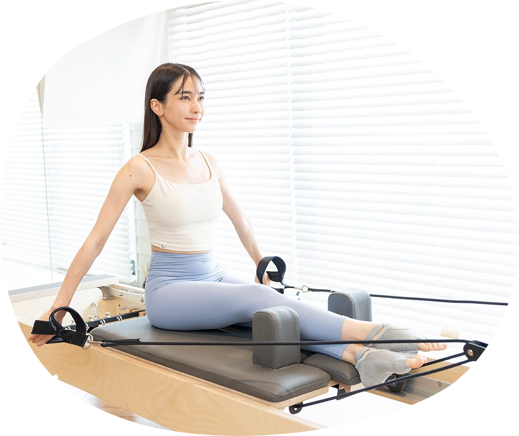 下北沢のピラティススタジオ Muniのリフォーマーベーシックレベル1プログラムを受ける女性